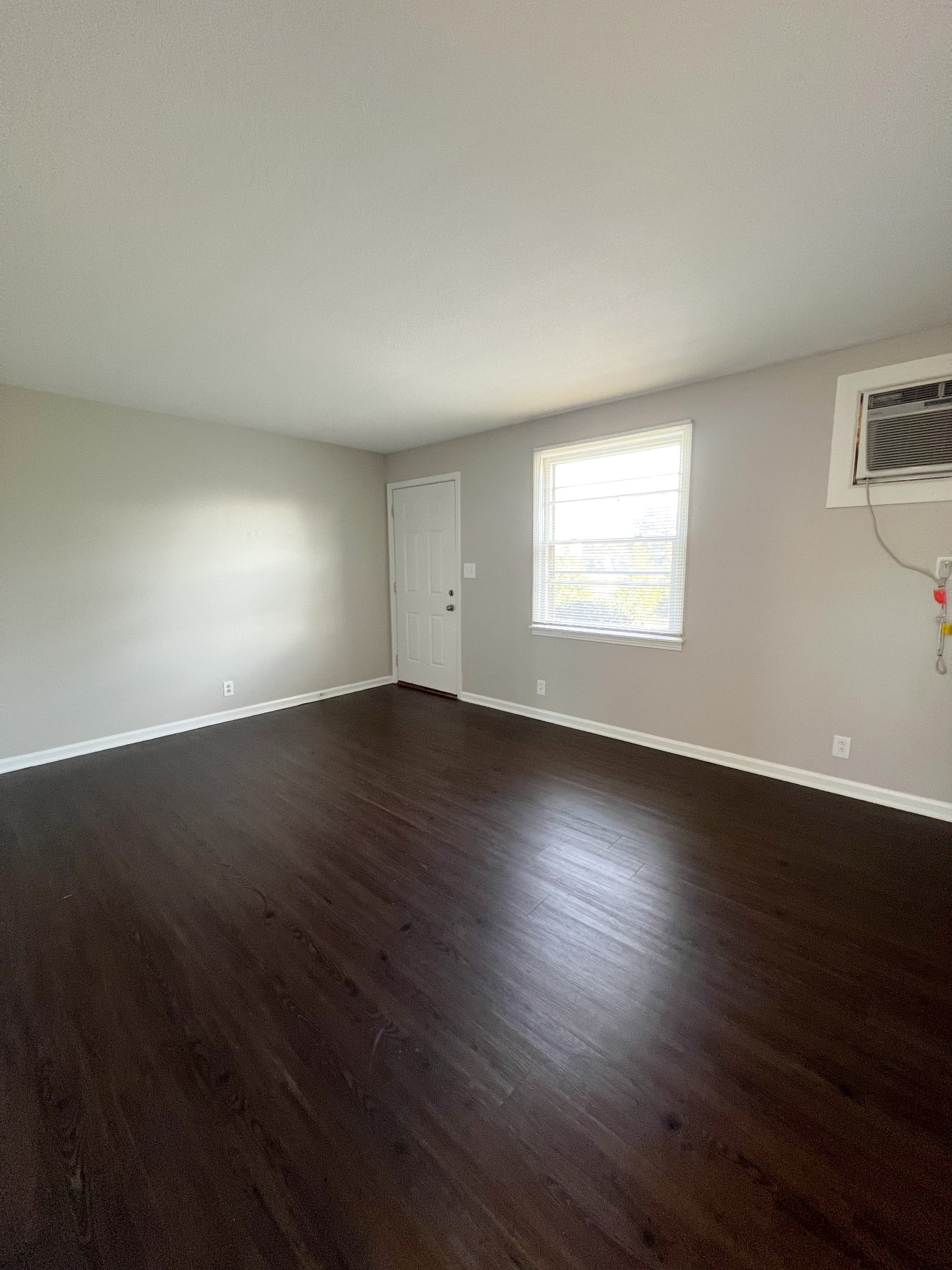 135 Airport Road, Unit C Clarksville, TN 37042 - Photo 5 of 16 an empty room with wooden floor and windows