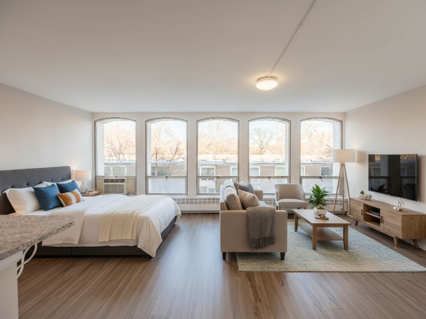 1401 East 55th Street, Unit 211N Chicago, IL 60615 - Photo 5 of 7 a spacious bedroom with a bed and large windows