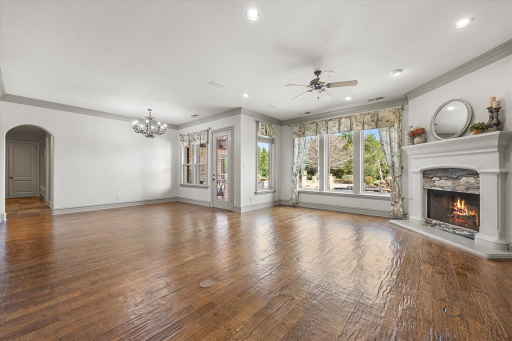161 Ridgemont Road Heath, TX 75126 - Photo 11 of 40 an empty room with fireplace wooden floor and windows