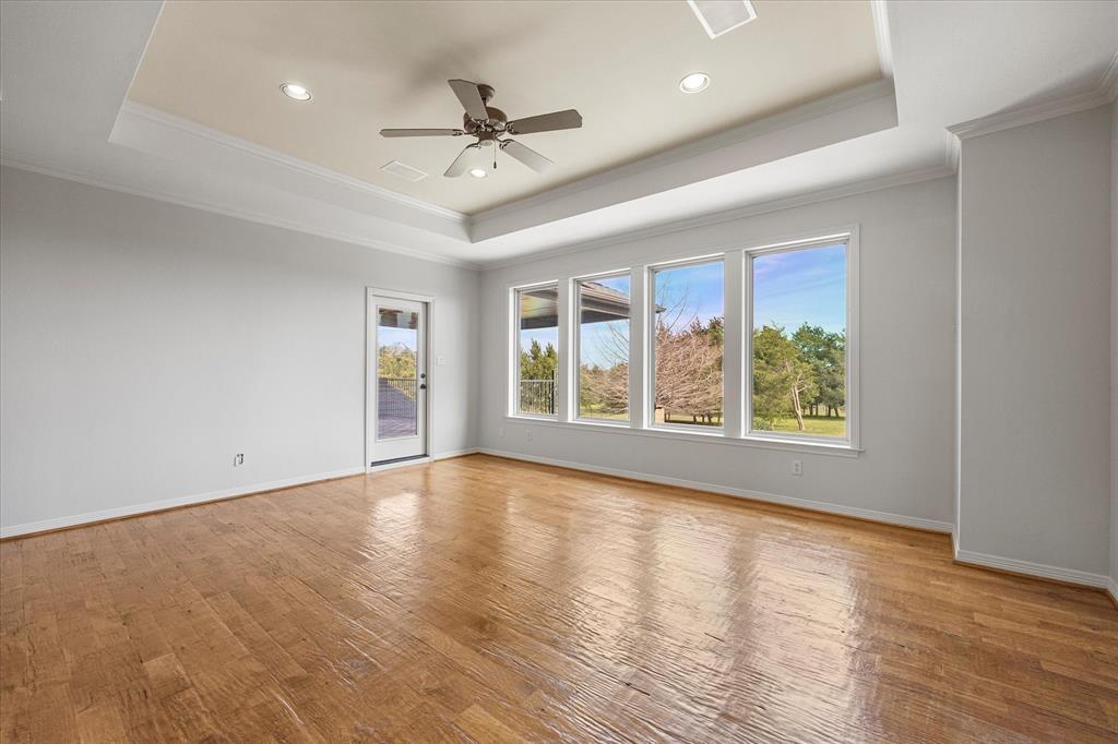 161 Ridgemont Road Heath, TX 75126 - Photo 25 of 40 a view of an empty room with a window and wooden floor