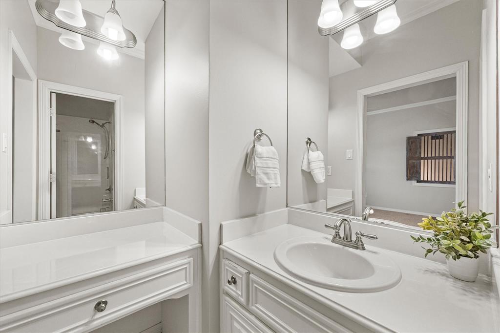 161 Ridgemont Road Heath, TX 75126 - Photo 27 of 40 a bathroom with a granite countertop sink a large mirror and vanity
