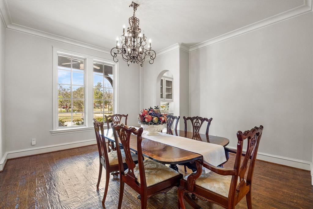 161 Ridgemont Road Heath, TX 75126 - Photo 7 of 40 a view of a dining room with furniture window chandelier and wooden floor