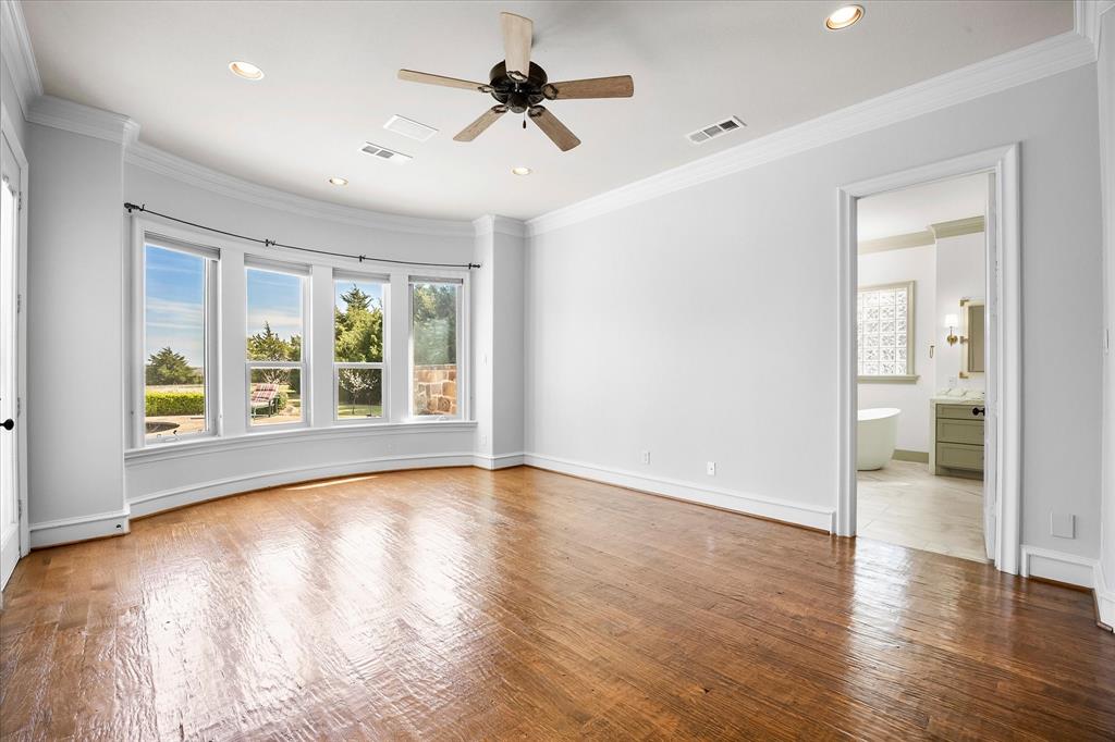 161 Ridgemont Road Heath, TX 75126 - Photo 8 of 40 a view of an empty room with a window and wooden floor