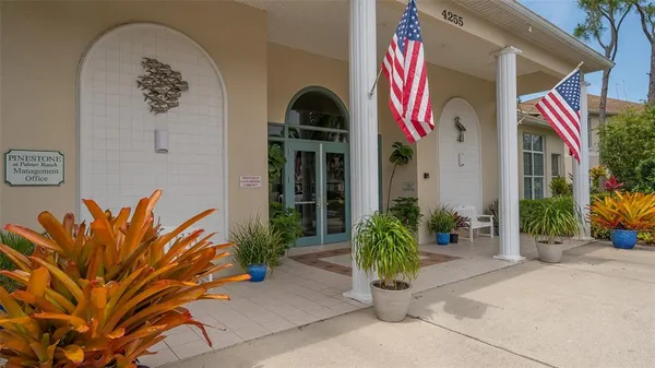 a building outdoor space with patio furniture and potted plants