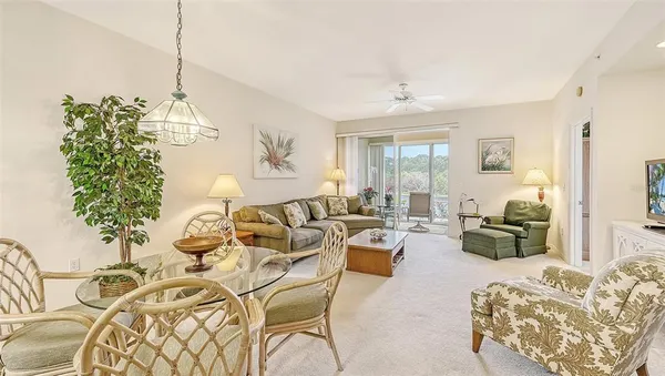 a living room with furniture and a chandelier