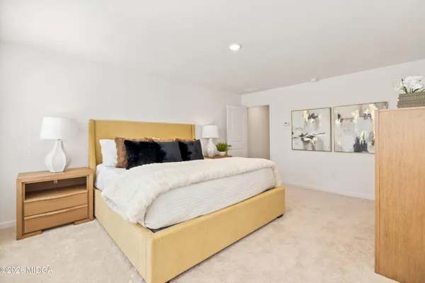 a bedroom with a bed and a lamp