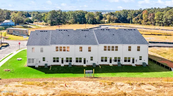 an aerial view of a house with a yard and plants