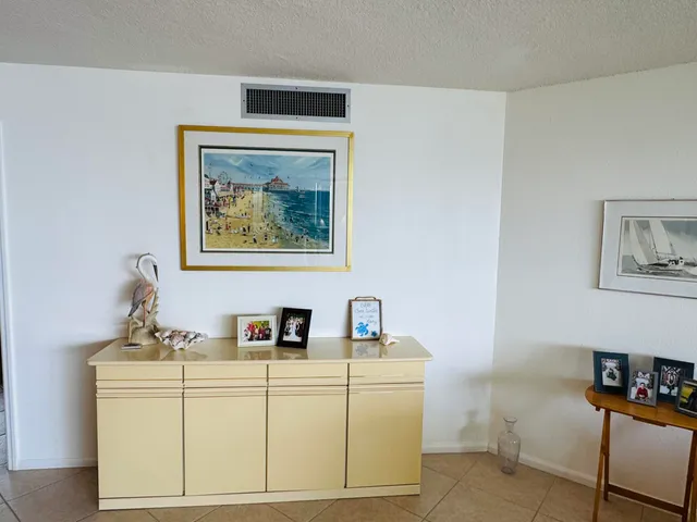 a living room with furniture and wall paintings