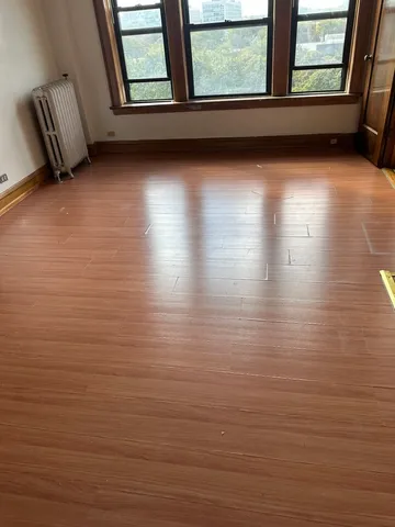 a view of a room with window and wooden floor