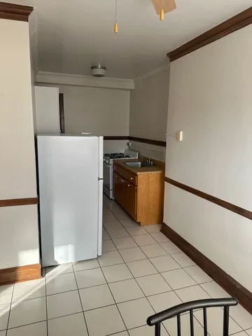 a kitchen with a stove and a refrigerator