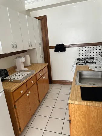 a kitchen with a stove a refrigerator and a sink