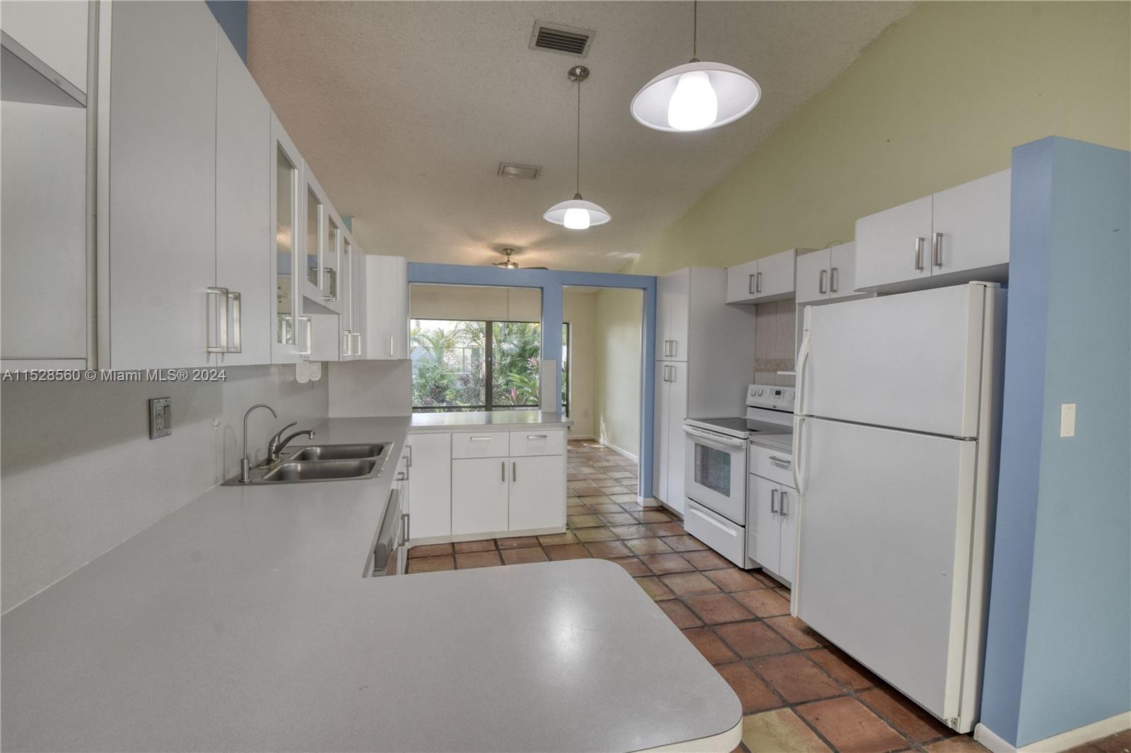 Kendall Miami, FL 33173 - Photo 2 of 8 a kitchen with a refrigerator a sink and cabinets
