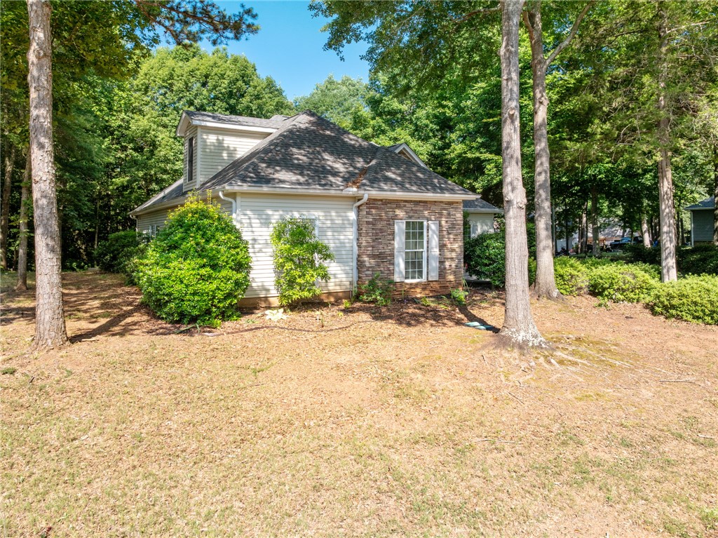 108 Winterbrook Circle Seneca, SC 29678 - Photo 4 of 40 A private, wood-lined setting surrounds this charming residence with a tasteful blend of siding and stone.