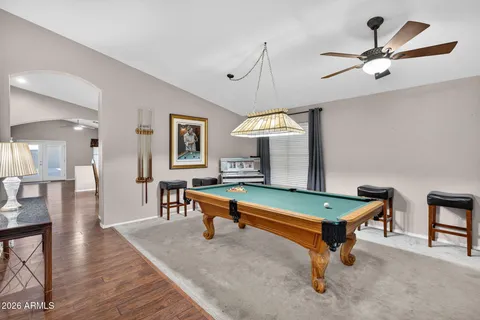 a living room with stainless steel appliances kitchen island granite countertop furniture wooden floor and a kitchen view
