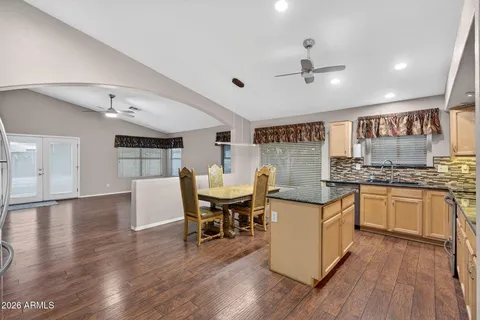 a view of a livingroom with a hardwood floor and a ceiling fan