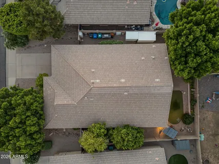 an aerial view of residential houses with outdoor space and parking