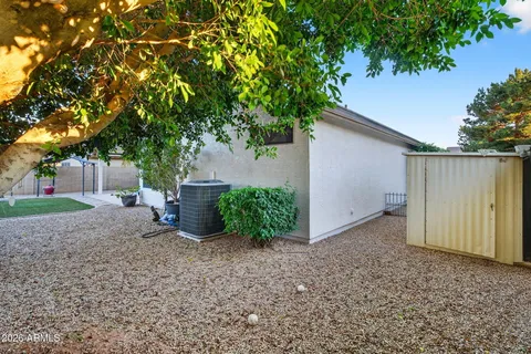 a view of a house with a backyard and sitting area