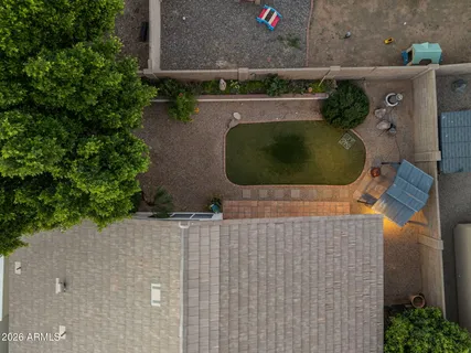 an aerial view of a house with plants and large trees