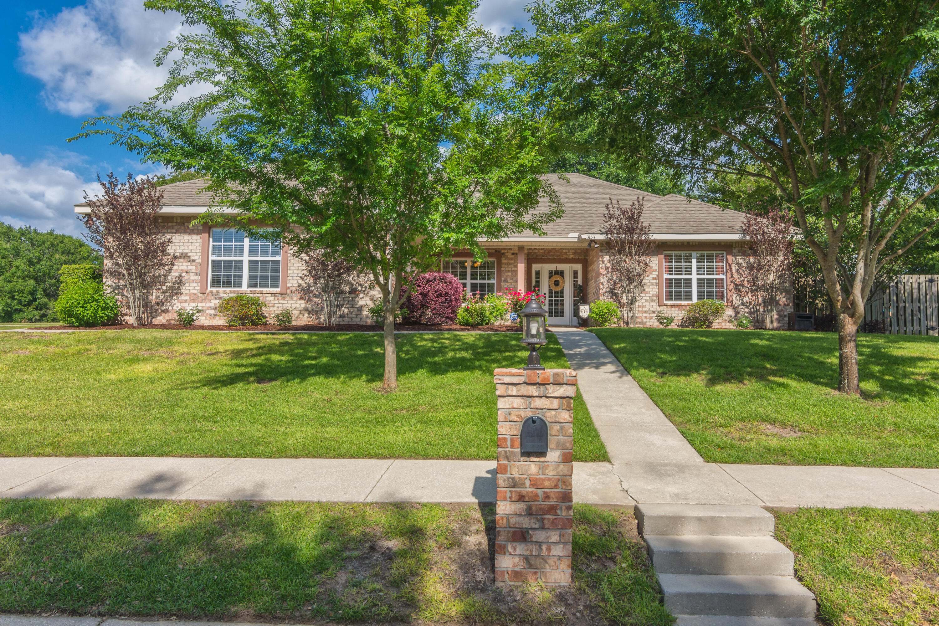 a front view of house with yard and green space