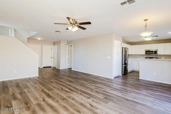 a kitchen with granite countertop white cabinets and a stove a sink