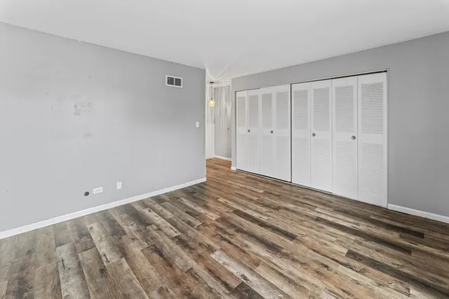a bathroom with a granite countertop sink a toilet and a mirror