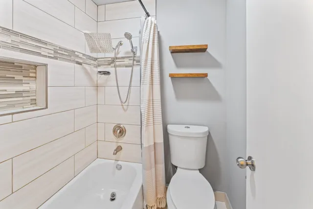 a bedroom with bed and a window