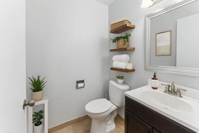 a bathroom with a sink toilet and a mirror