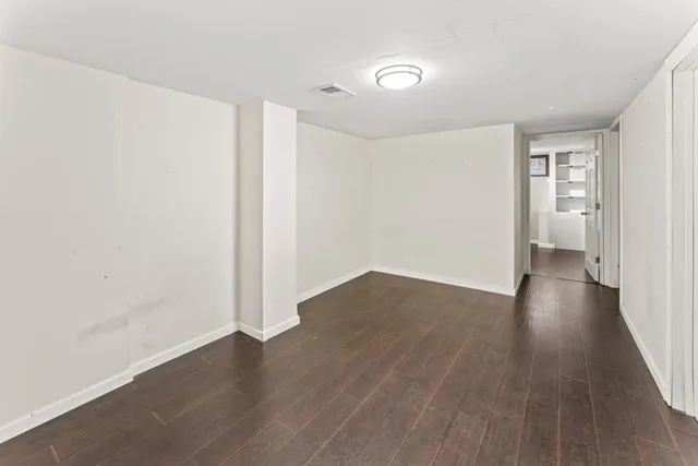 a view of a room with wooden floor