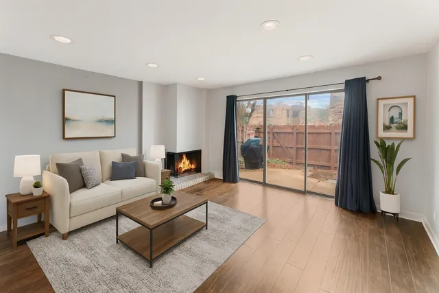 a living room with furniture a flat screen tv and a floor to ceiling window