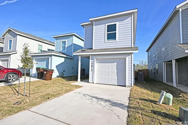 a view of a house with a patio and a yard