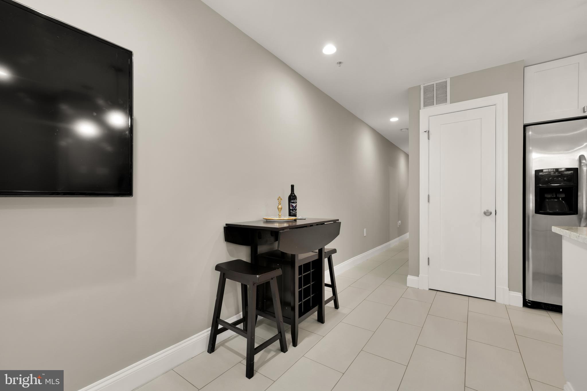 1135 6th Street Northwest, Unit 1 Washington, DC 20001 - Photo 12 of 33 a view of a workspace with furniture and a flat screen tv