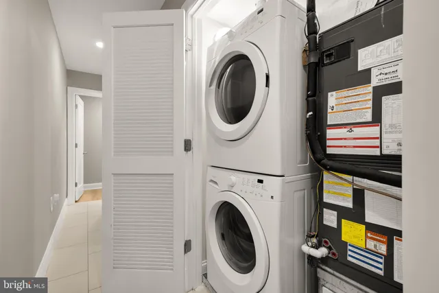 a view of a storage & utility room with a washer dryer