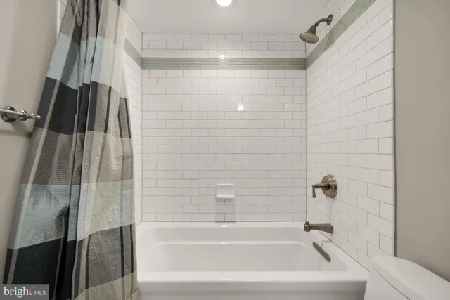 a bathroom with a shower and a bath tub