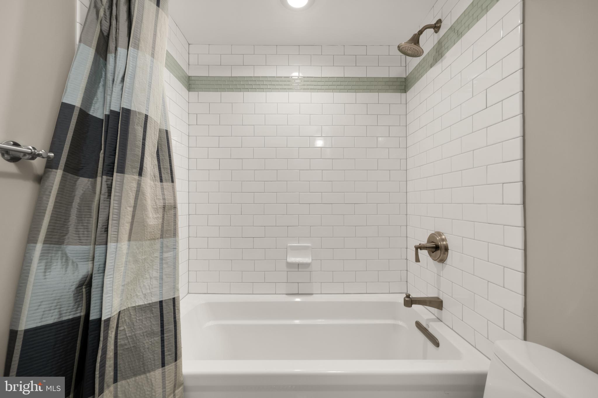 1135 6th Street Northwest, Unit 1 Washington, DC 20001 - Photo 23 of 33 a bathroom with a shower and a bath tub