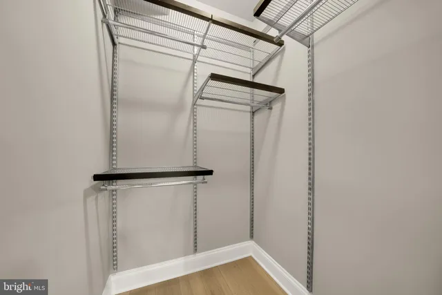 a view of walk in closet with clothes