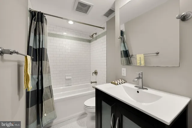 a bathroom with a sink shower and a mirror