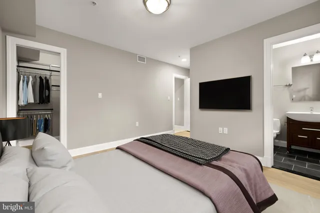a bedroom with a bed and a flat screen tv