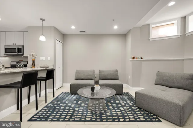 a living room with furniture a rug and a fireplace