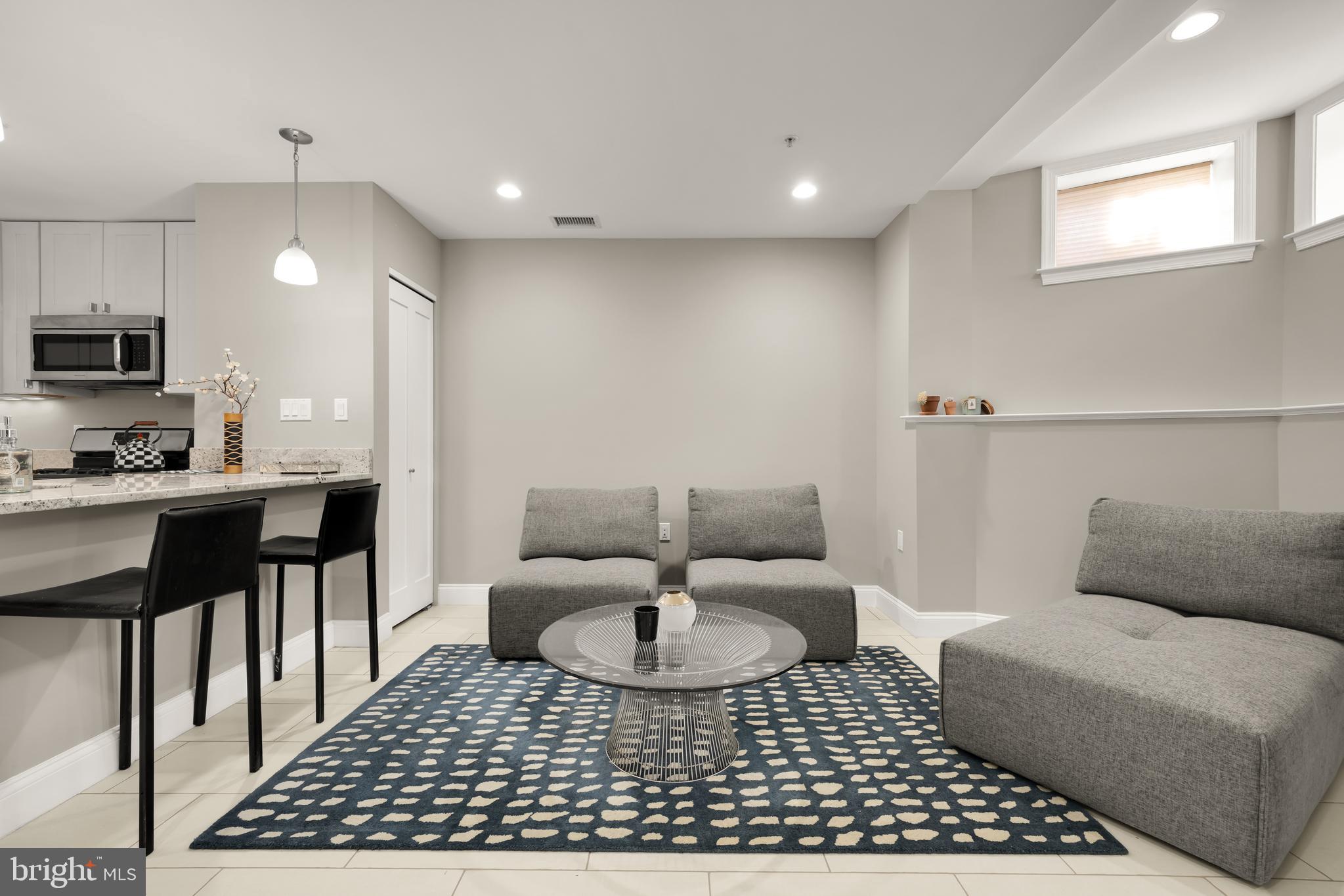1135 6th Street Northwest, Unit 1 Washington, DC 20001 - Photo 3 of 33 a living room with furniture a rug and a fireplace