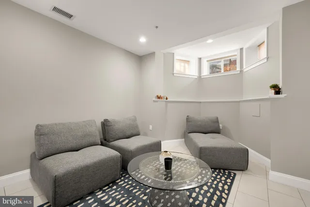 a living room with furniture and a rug