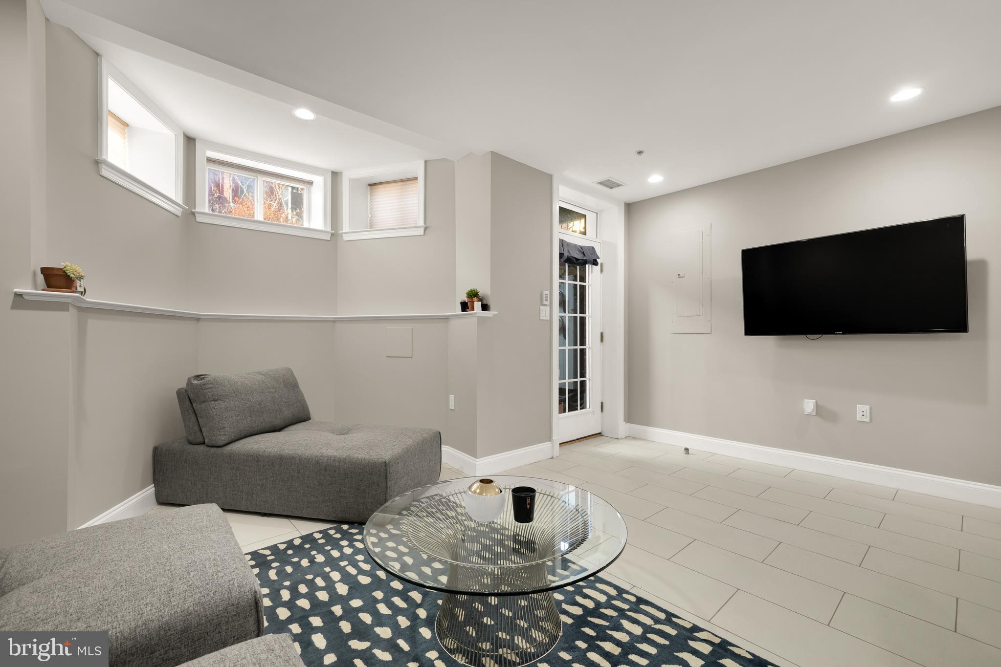 1135 6th Street Northwest, Unit 1 Washington, DC 20001 - Photo 8 of 33 a living room with furniture and a flat screen tv