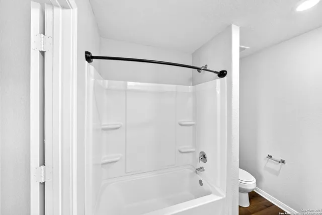 a bathroom with a bathtub and a shower