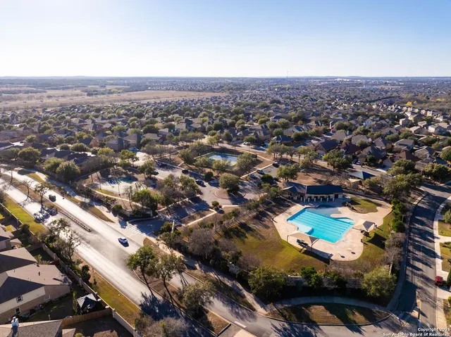 an aerial view of residential houses with city view
