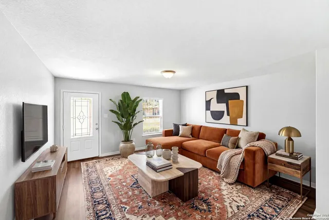 a living room with furniture and a flat screen tv