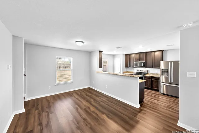 a kitchen with stainless steel appliances a refrigerator sink and stove