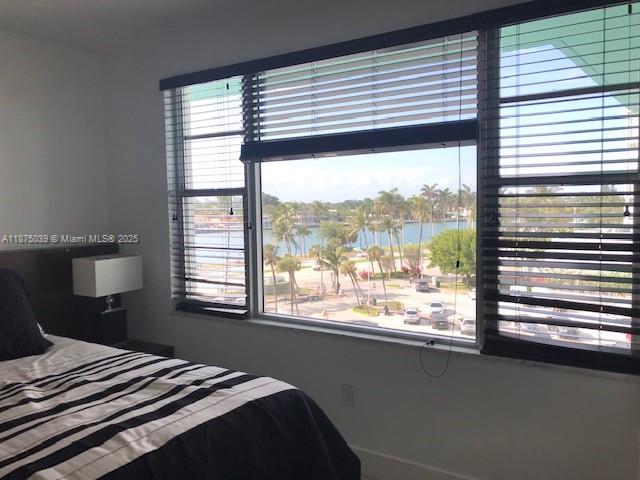 5255 Collins Avenue, Unit 4G Miami Beach, FL 33140 - Photo 13 of 30 a bedroom with a bed and a large window