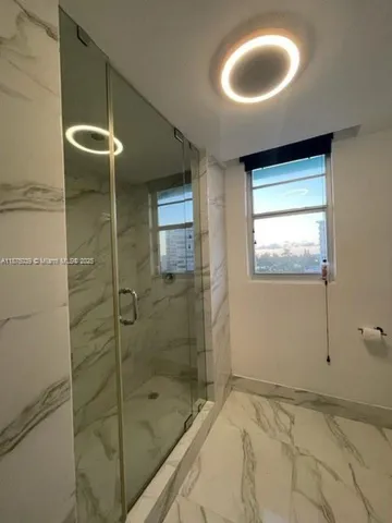 a bathroom with a bathtub and a shower