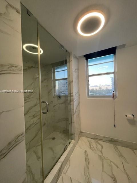 5255 Collins Avenue, Unit 4G Miami Beach, FL 33140 - Photo 17 of 30 a bathroom with a bathtub and a shower