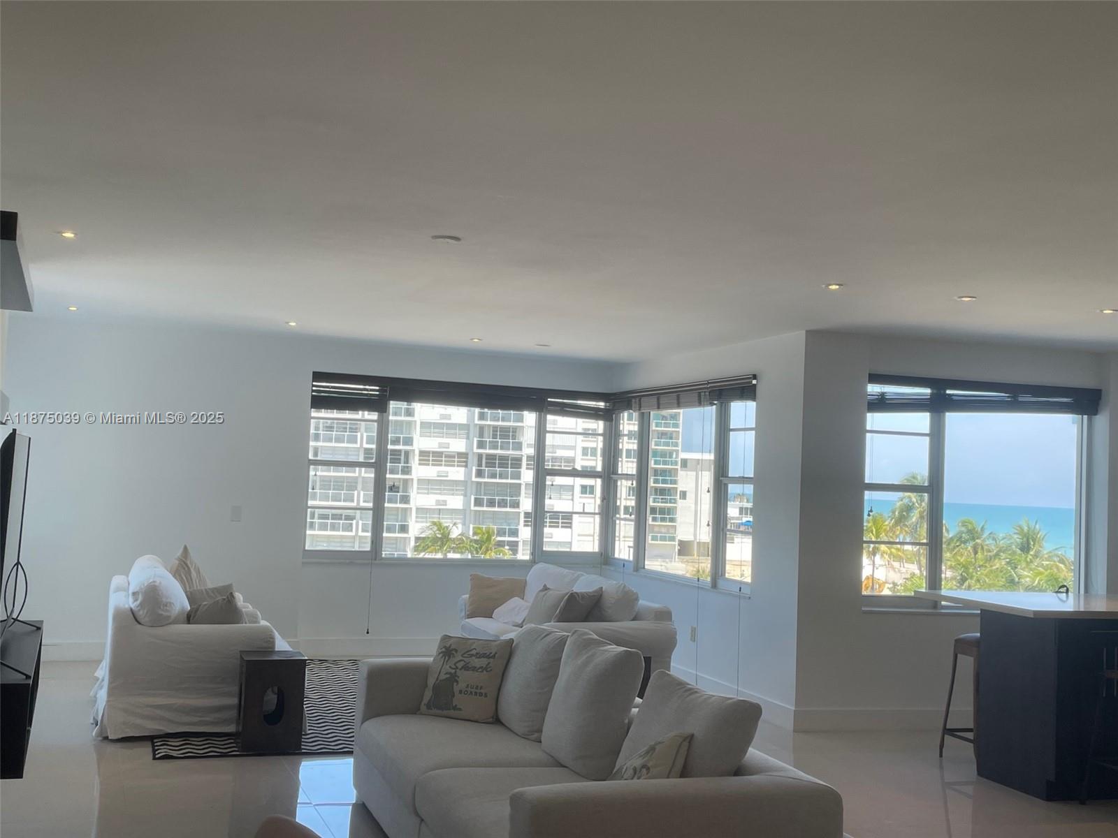 5255 Collins Avenue, Unit 4G Miami Beach, FL 33140 - Photo 10 of 30 a living room with furniture and a window