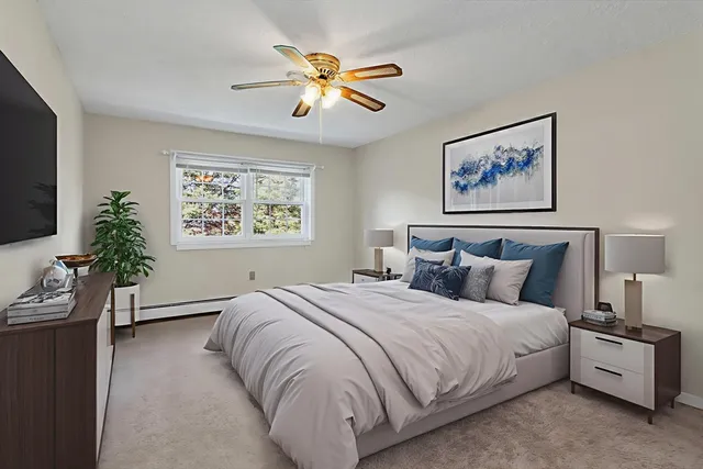 a bedroom with a large bed and a chandelier